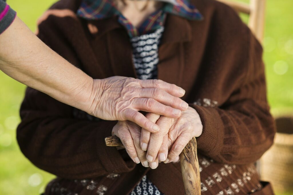 graphicstock-closeup-of-caring-woman-holding-female-seniors-hands_HAdOpB2-W